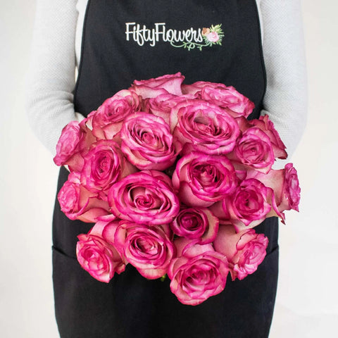 bunch of white roses with pink edge held in hand